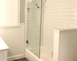 3/8” clear glass movable panel with chrome glass to wall hinges