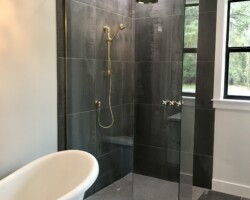 3/8” clear fixed panels with shiny gold u channel and slip over clips