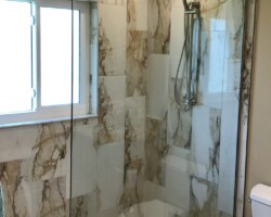 1/2” clear fixed panel with brushed nickel u channel and vertical support bar