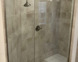 3/8” clear glass fixed panels with brushed nickel u channel and slip over clip