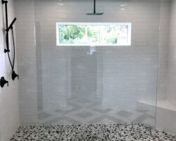 1/2” clear fixed panel glass with brushed nickel u channel on bottom and top clamps