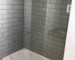 3/8” movable clear glass panel with chrome glass to wall hinges