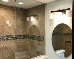 3/8” clear fixed panel glass with brushed nickel channel on 3 sides