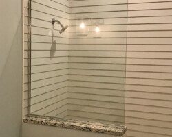 3/8” clear fixed panel glass with chrome channel on 2 sides
