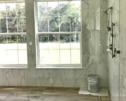1/2” clear fixed panel glass with brushed nickel clamps