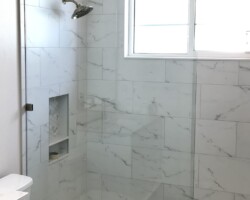 3/8” clear fixed panel glass with brushed nickel clamps