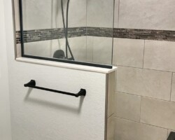 3/8” clear fixed panel glass with oil rubbed bronze channel on 2 sides