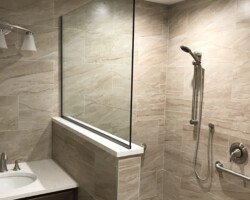 3/8” clear fixed panel glass with brushed nickel channel on 2 sides