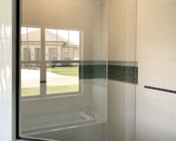 3/8” clear fixed glass panels with oil rubbed bronze channel and slip over clip