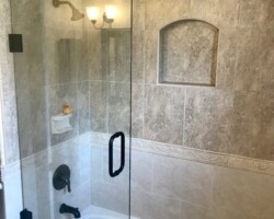 3/8” clear movable panel with matte black glass to wall hinges and bore thru c pull handle