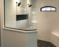 3/8” clear glass fixed panels with matte black channel and slip over clip