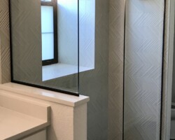 3/8” clear fixed glass panels with matte black channel on 2 sides