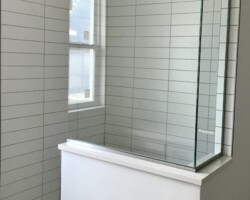 3/8” clear glass fixed panels with brushed nickel channel and slip over clip