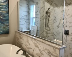 1/2” clear fixed panel glass with brushed nickel channel on 2 sides