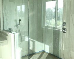 1/2” clear glass fixed panels with knee wall notch, chrome channel and slip over clip