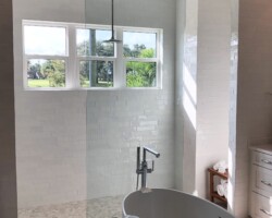 1/2” clear glass fixed panel with chrome bottom channel and top clamps